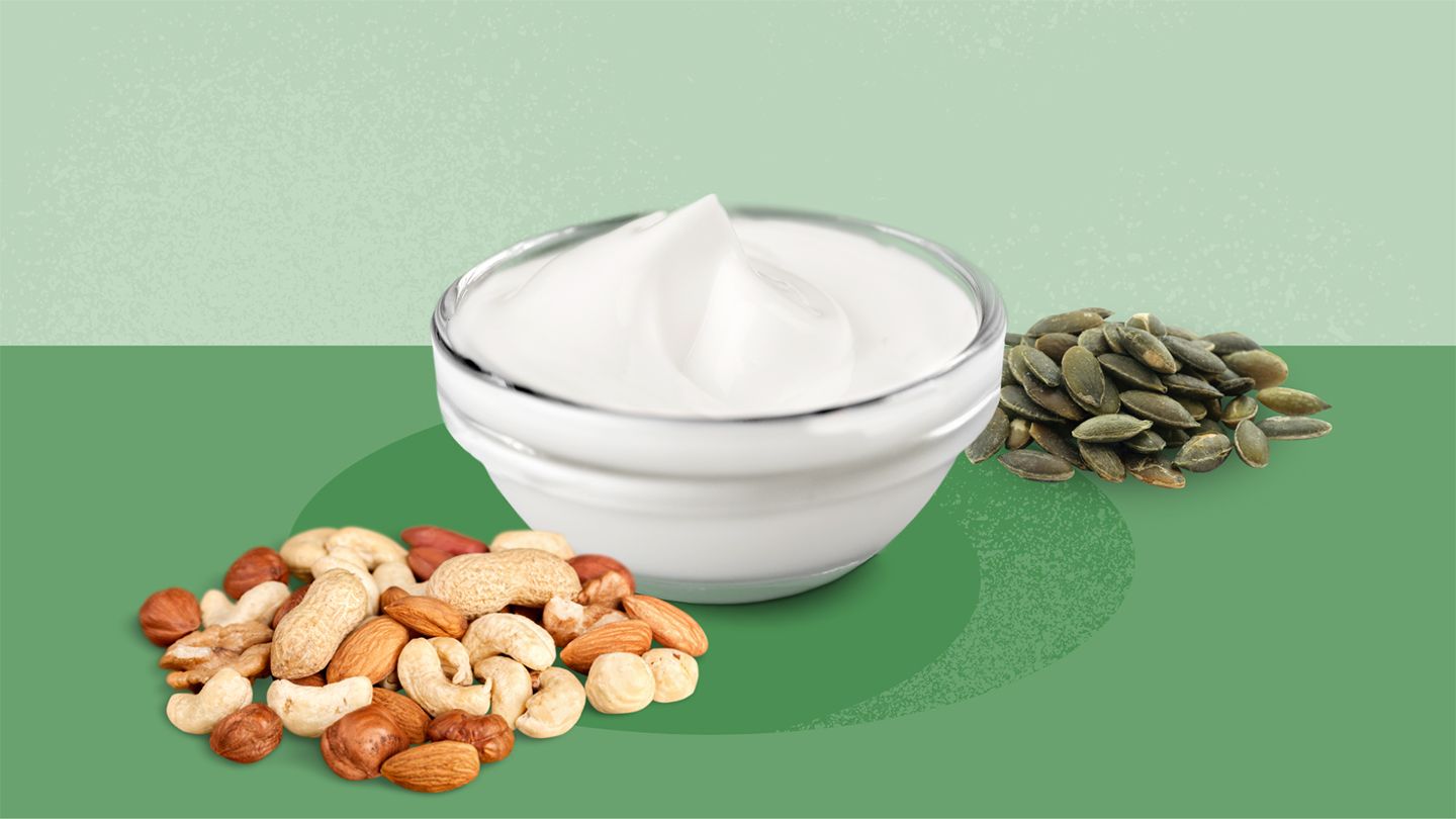 mixed nuts, yogurt, and pumpkin seeds on a green background
