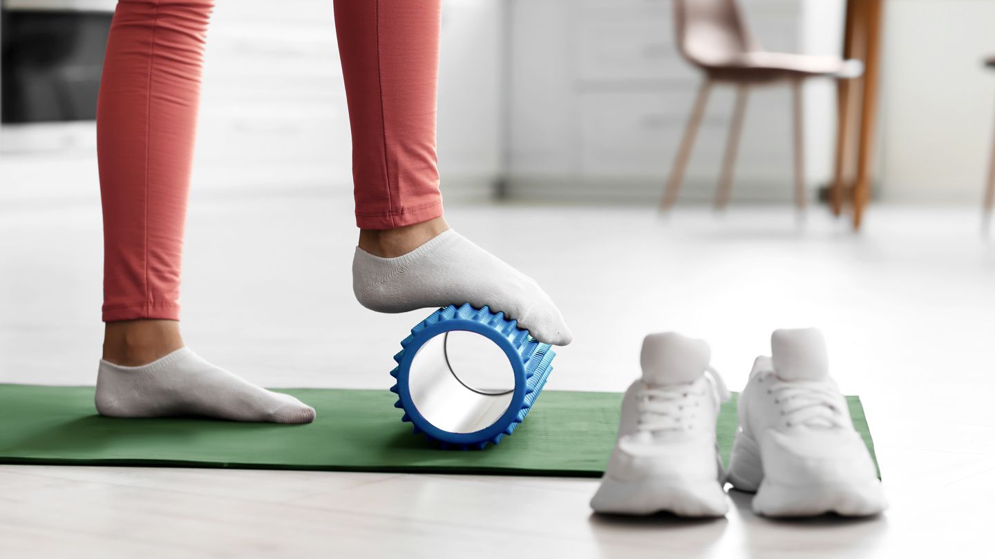 woman massaging food with foam roller