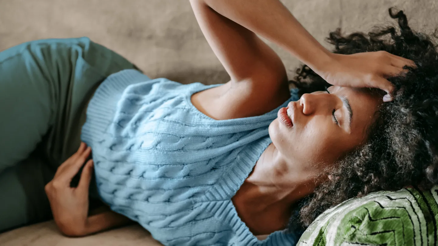 woman on the couch in pain