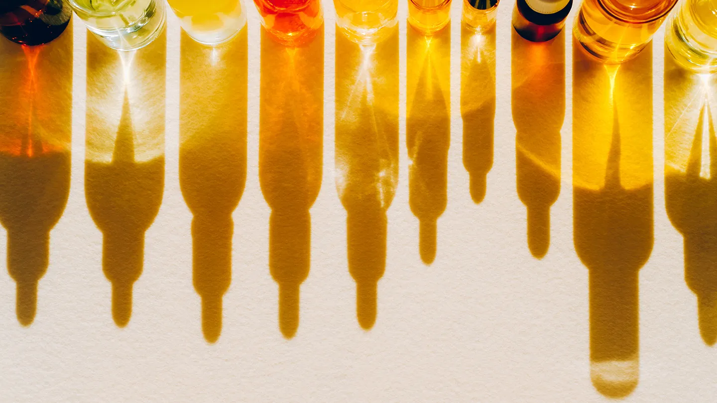 Essential-Oil bottle reflections light creates abstract patterns from shadows