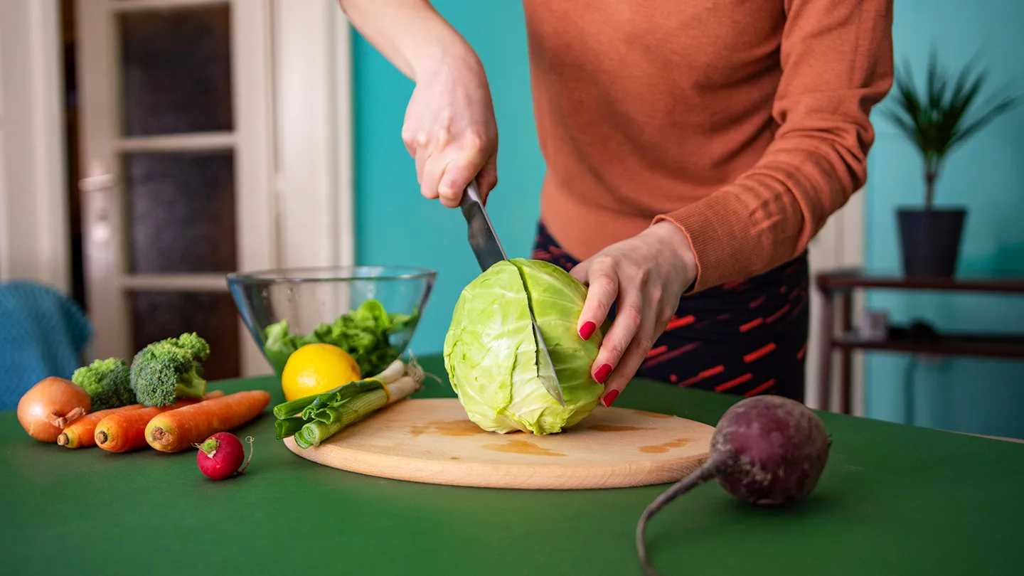 woman cutting cabbage healthy
