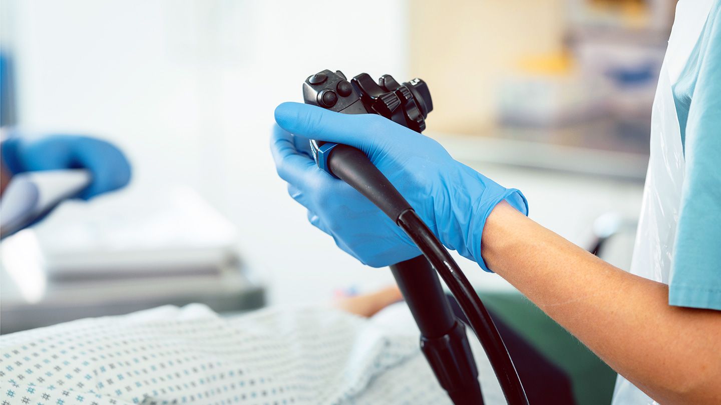 Doctor holding endoscope during colonoscopy screening