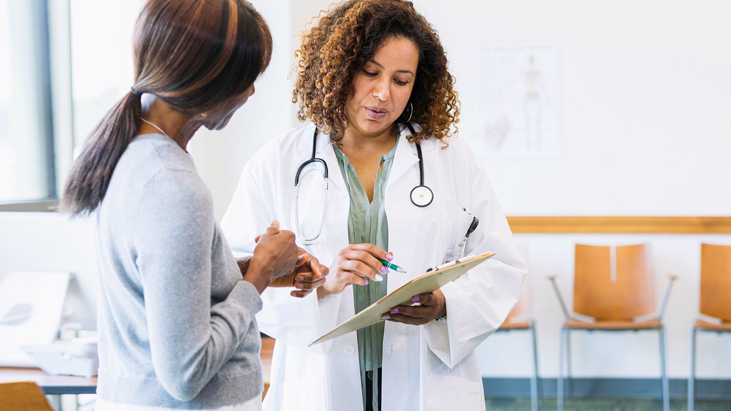 asking treatment questions of doctor head and neck cancer black woman