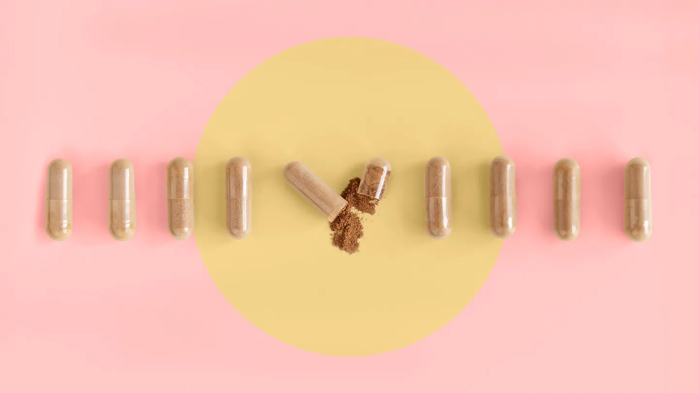rhodiola supplement capsules on coral background and yellow circle