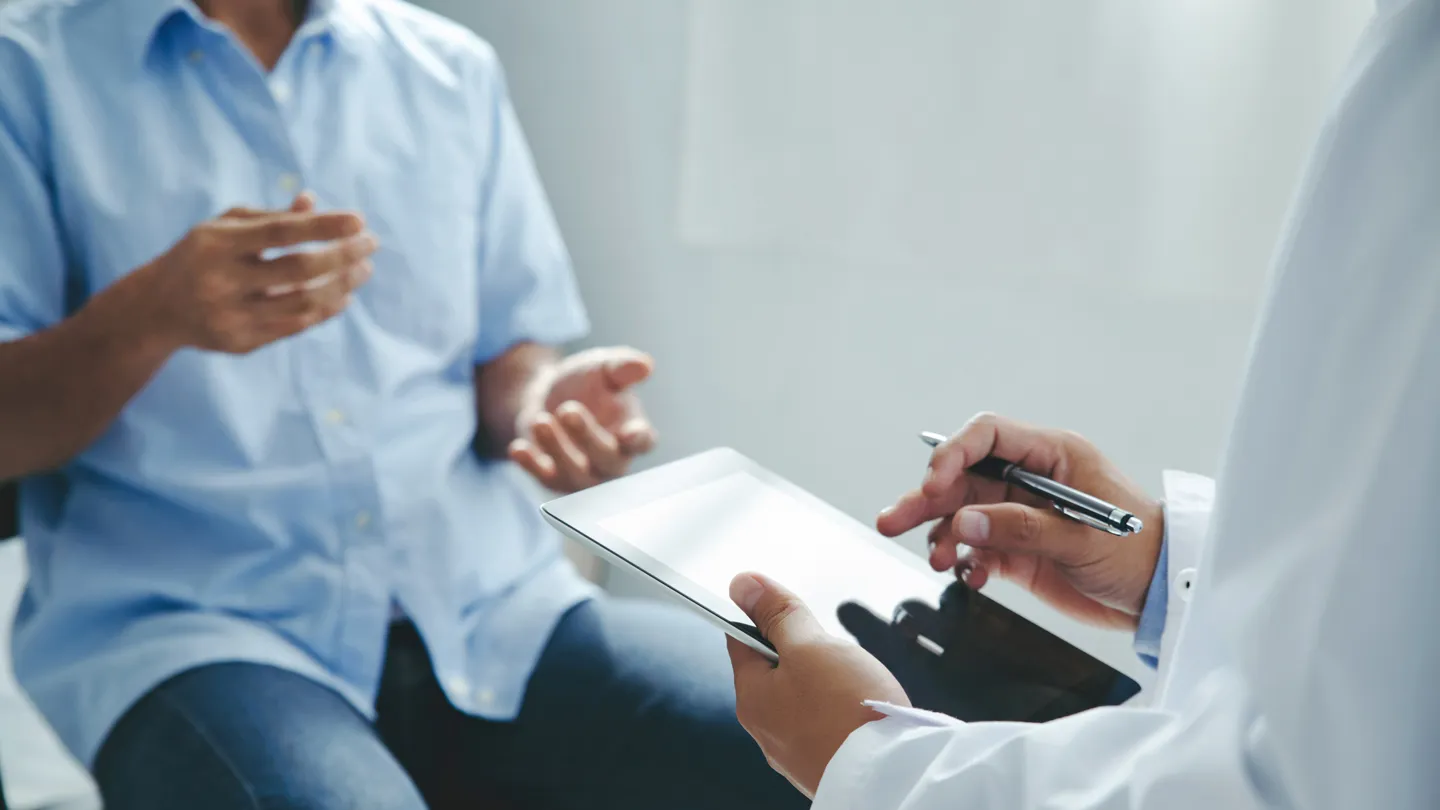 man talking with his doctor