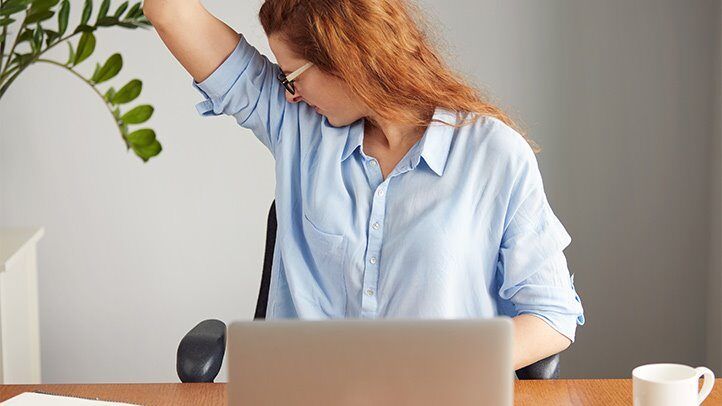 a woman checking for underam sweat