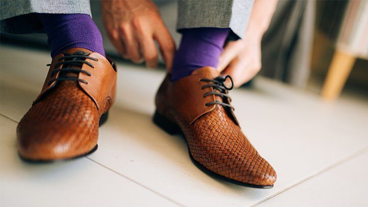 a man checking his feet for sweat