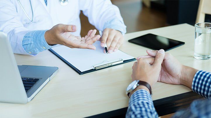 a person talking to their doctor about excessive sweating