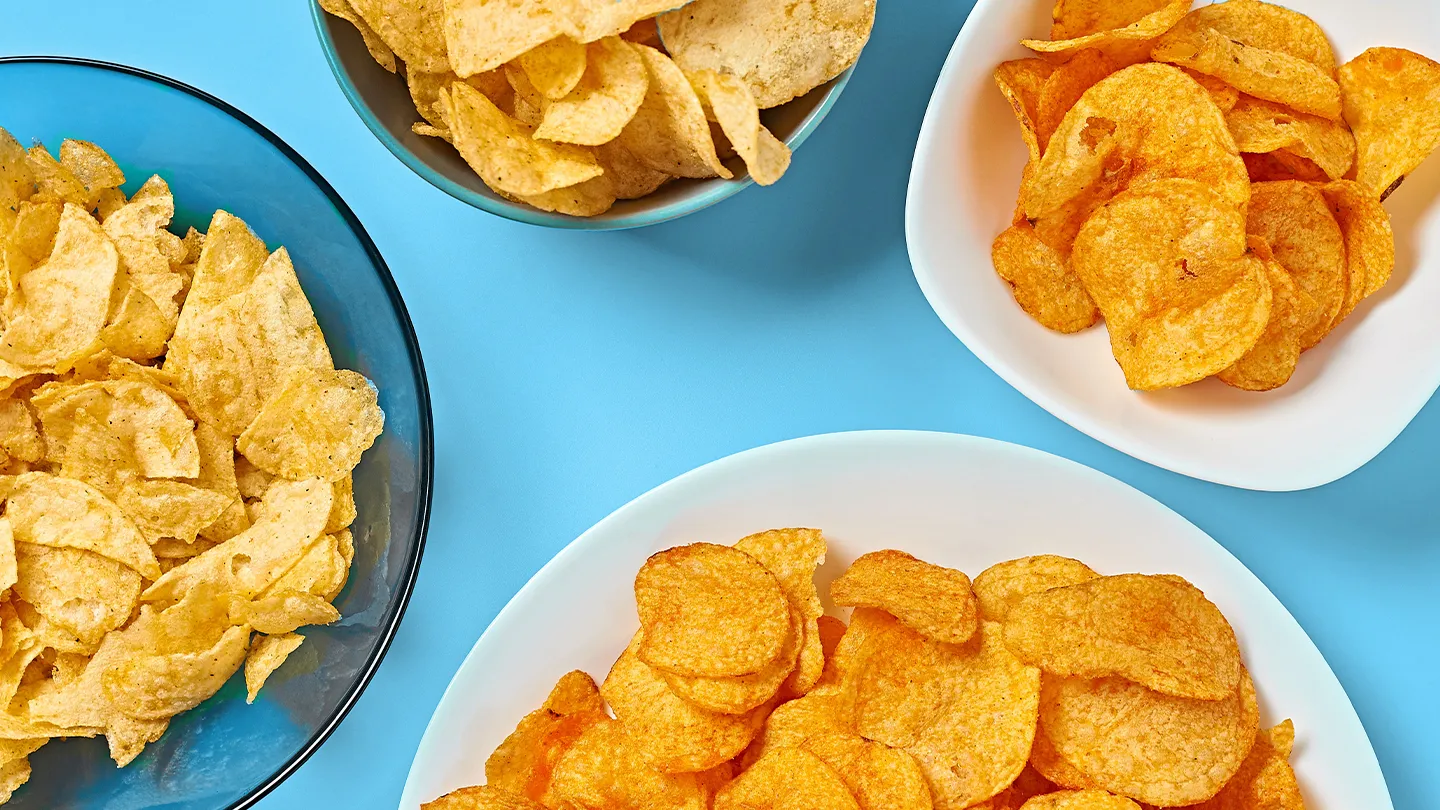 bowls of chips on blue background