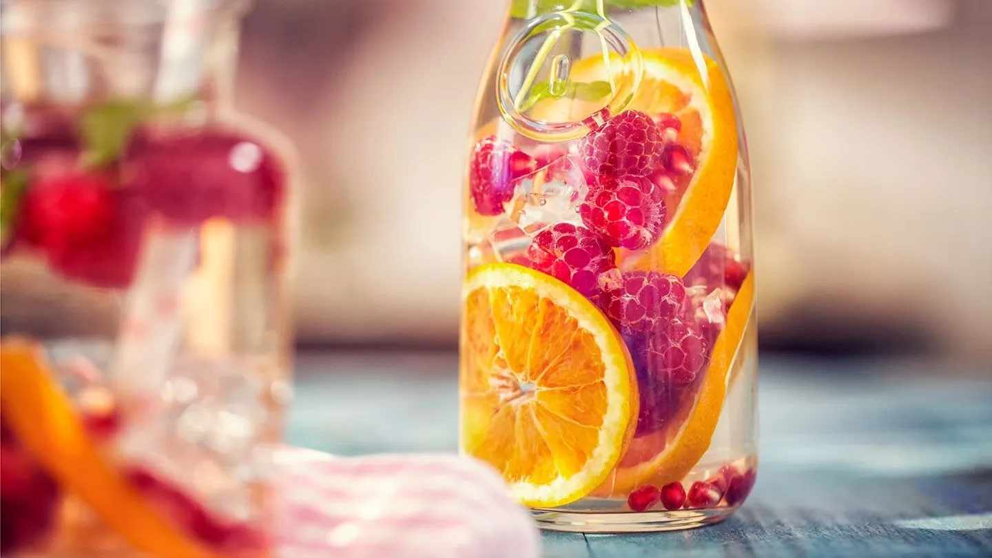 a pitcher of water with fruit inside