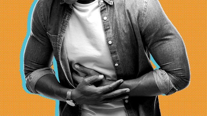 a man holding his abdomen, experiencing symptoms of a gallbladder problem