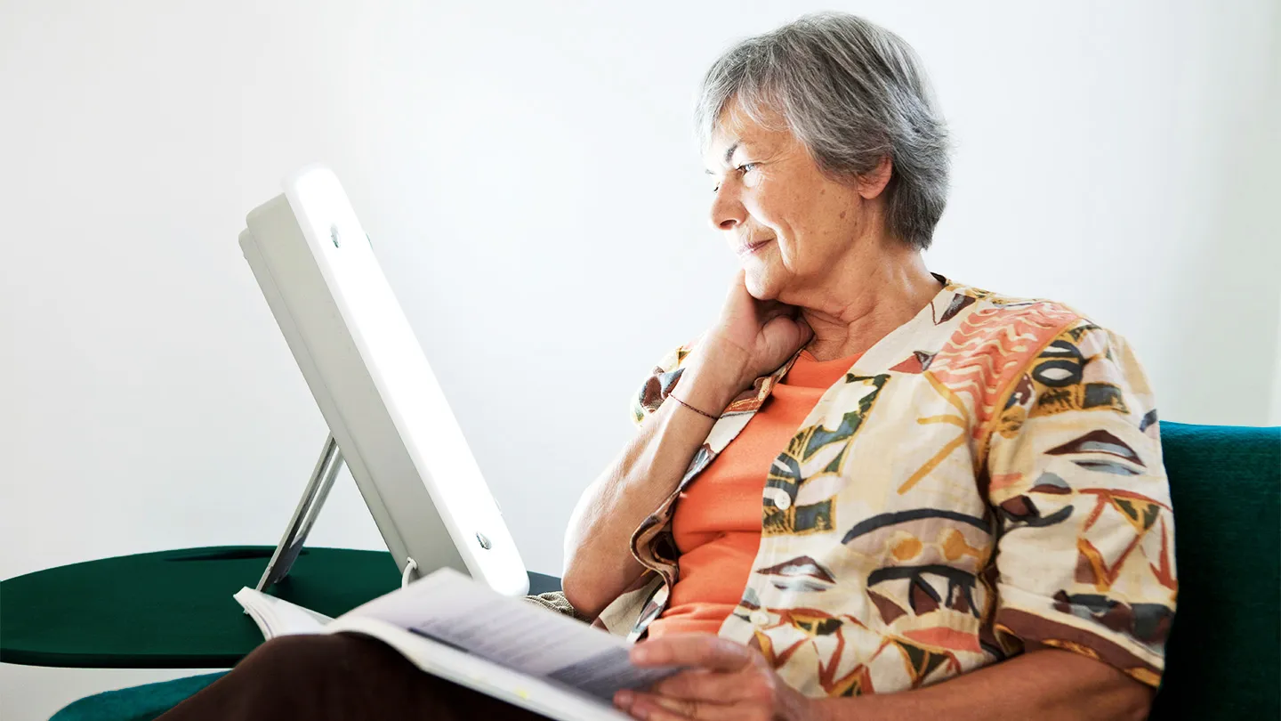 woman using SAD lamp for depression