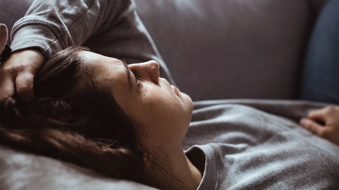 fatigued woman on couch