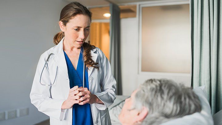 a doctor talking to a patient after surgery