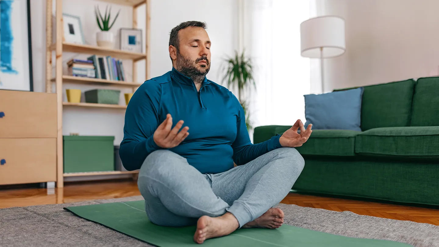a man meditating at home
