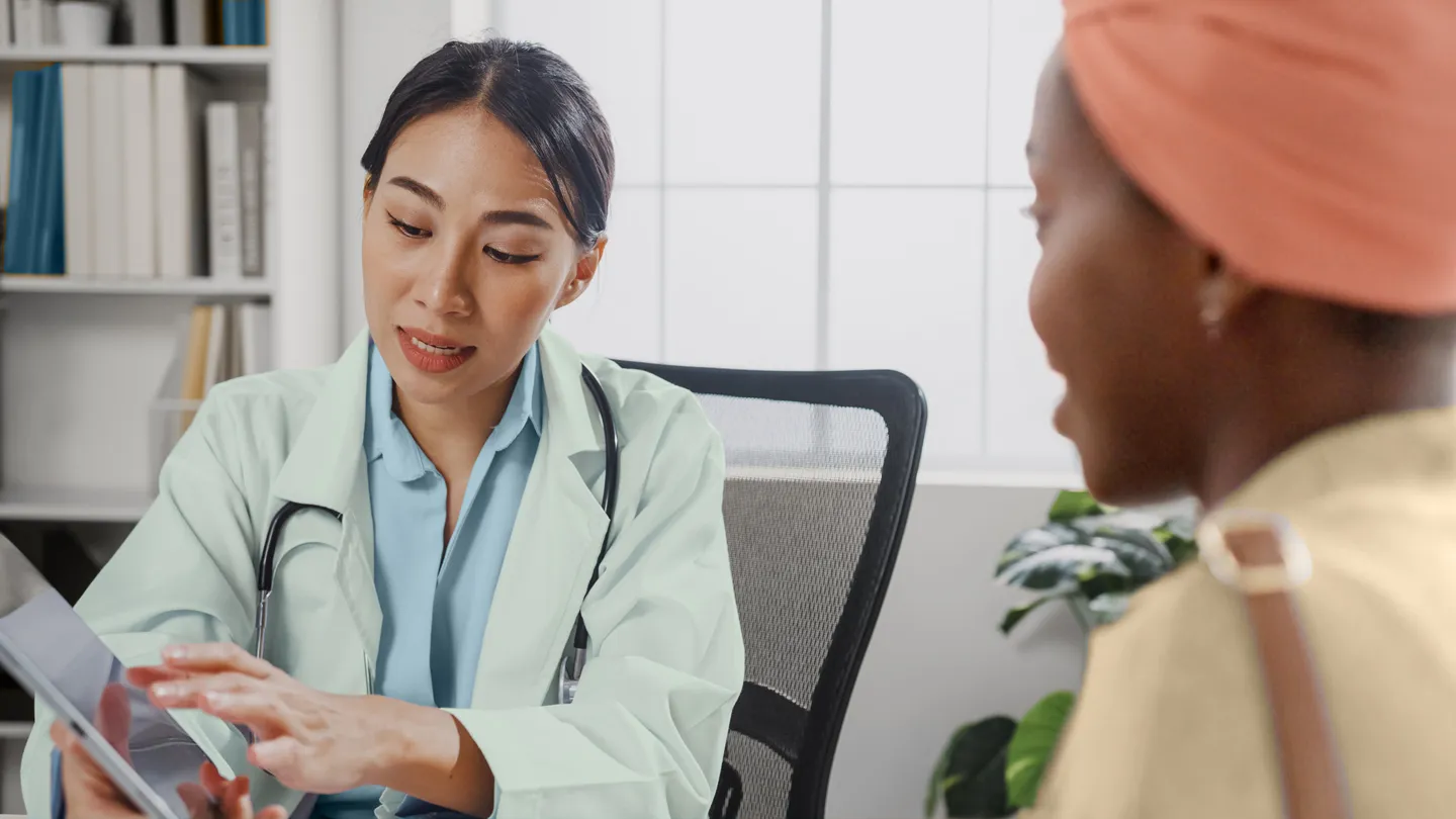 Black woman patient getting treatment option information from her oncologist