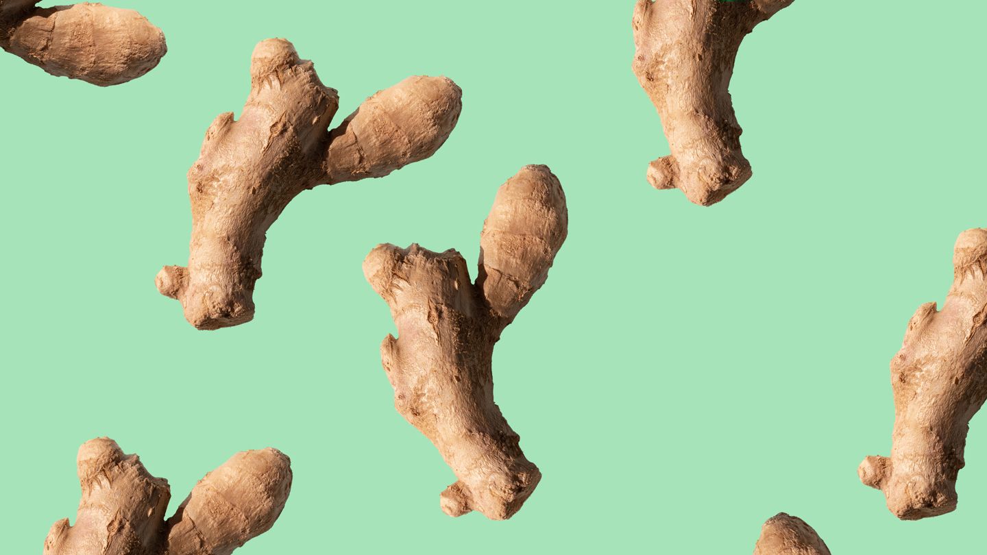 Tumeric roots against green background
