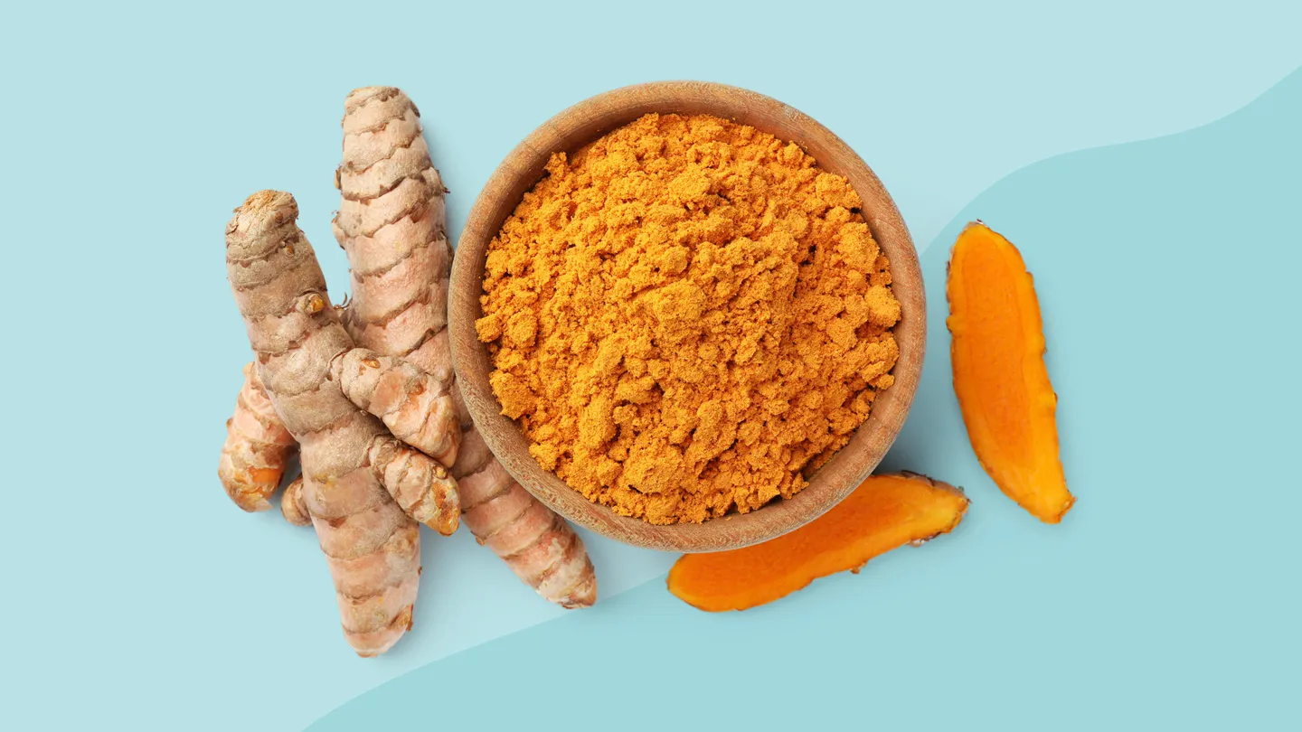 Turmeric root with ground powder and sliced versions on blue