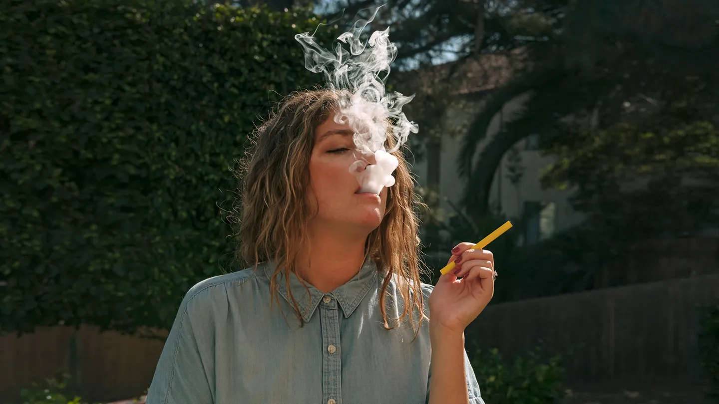 woman vaping e-cigarette outdoors