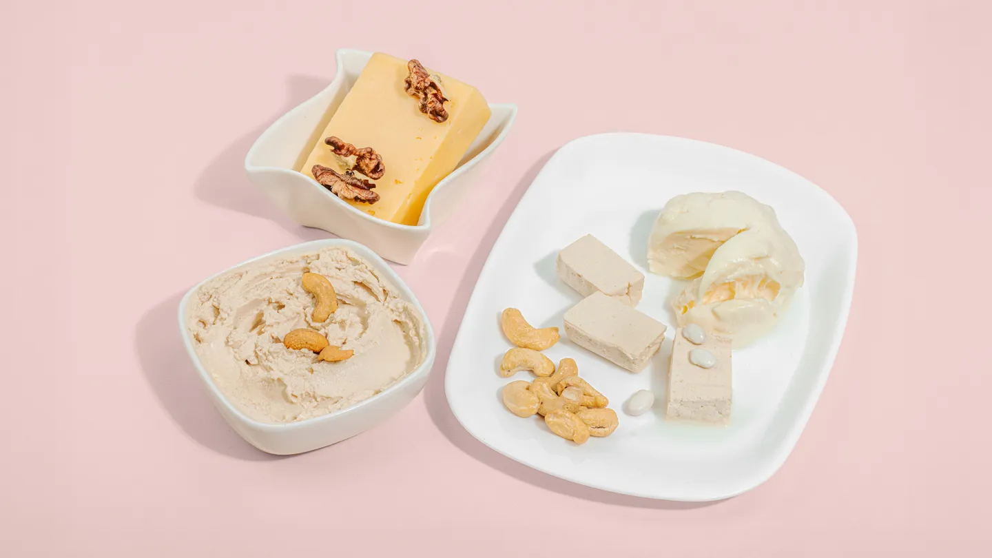 Variety of vegan cheeses on white plates