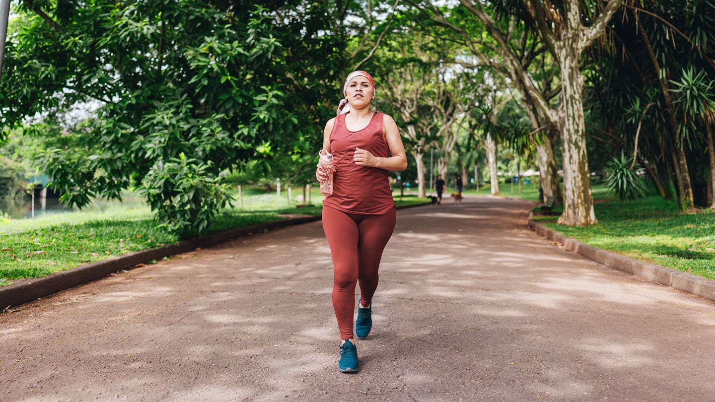 cancer survivor fast walking jogging in the park