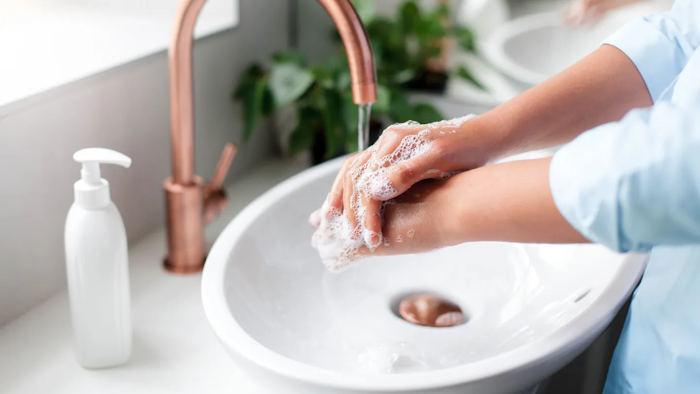 woman washing hands with soap
