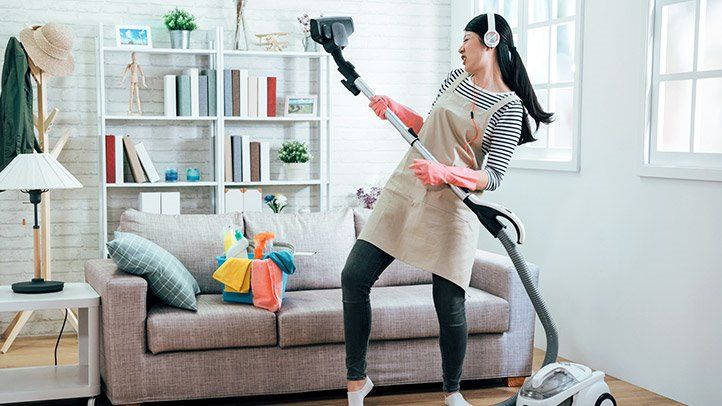 a person cleaning their house as a way to exercise at home