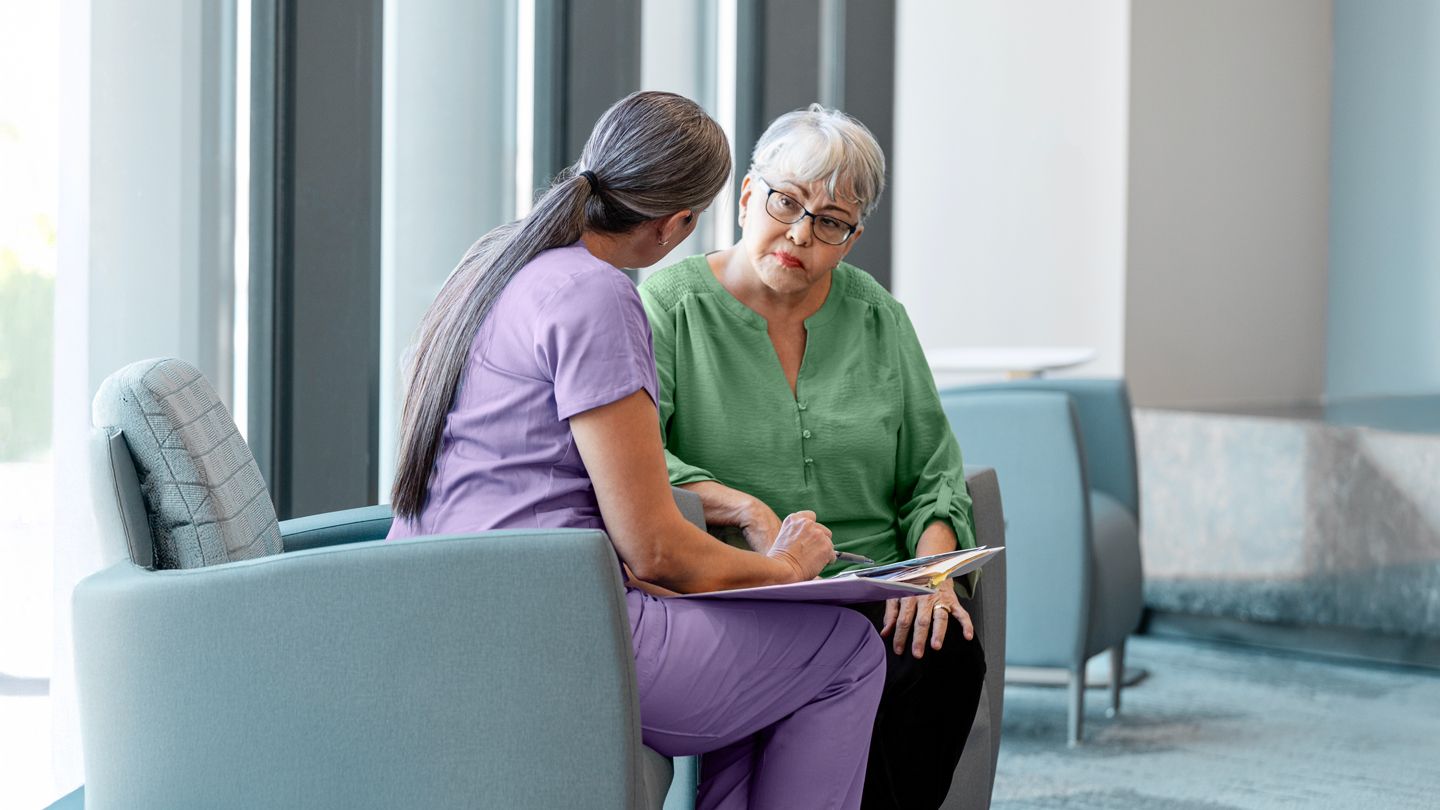 senior hispanic woman talking wit her doctor about test results