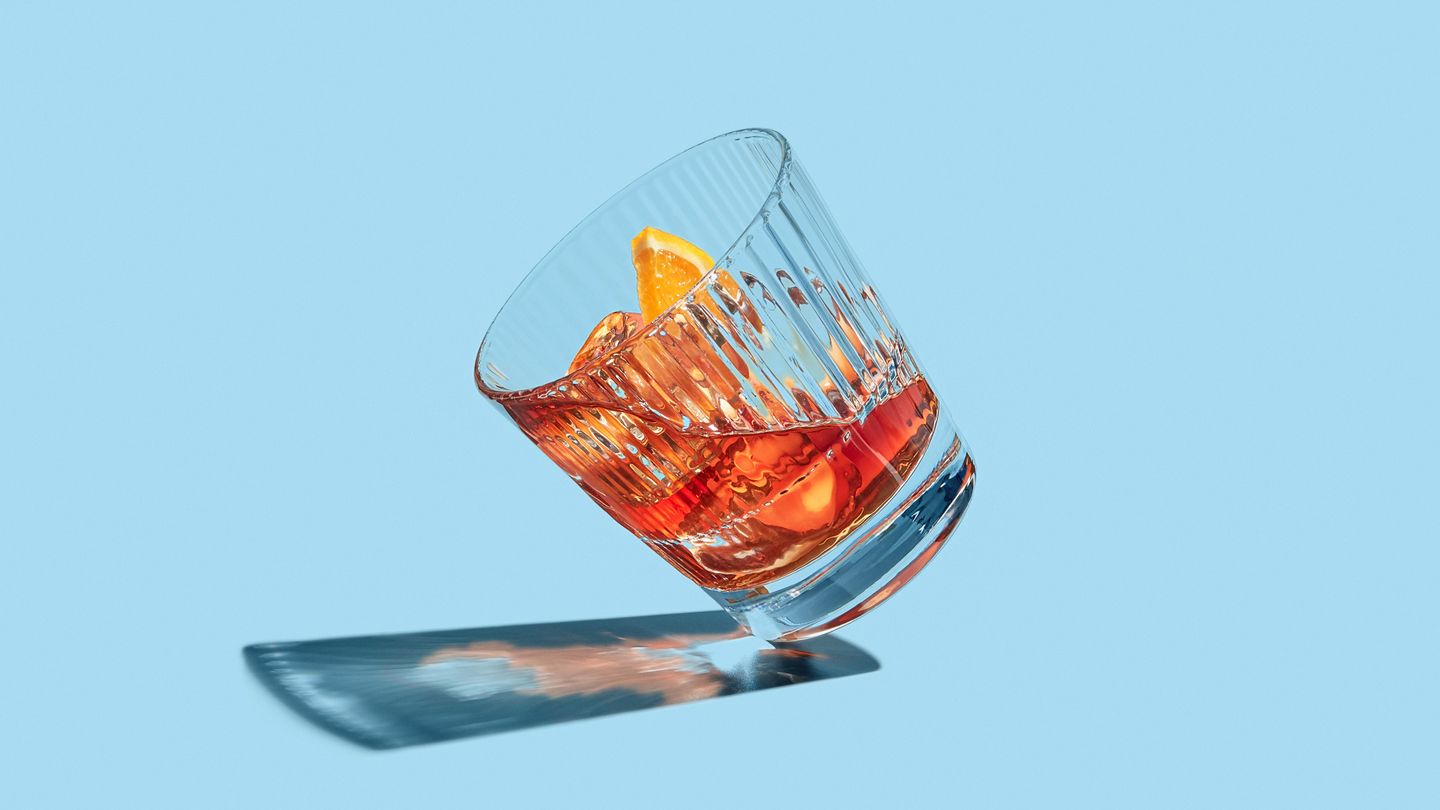 teetering glass of whisky still life