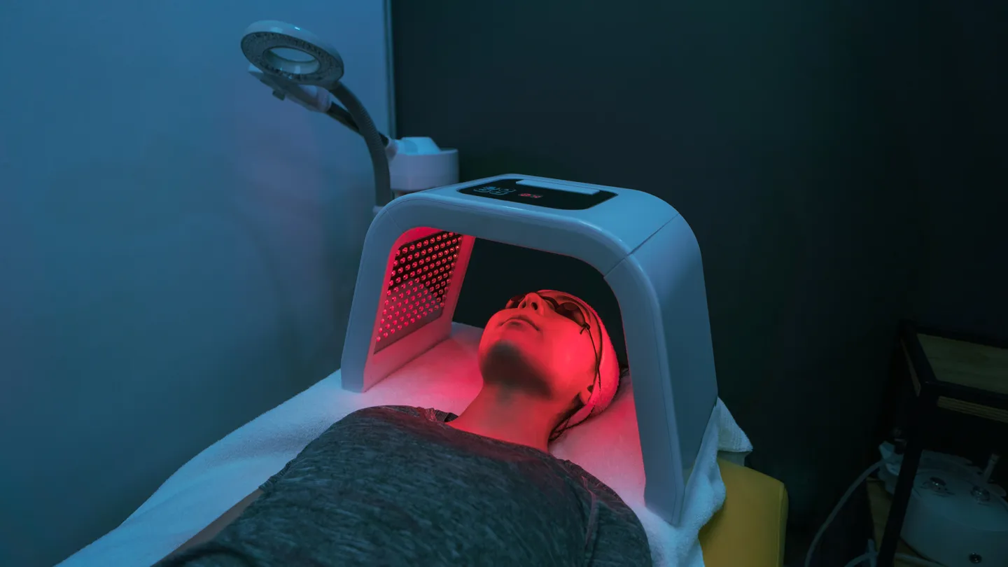 Young woman getting red light therapy on face