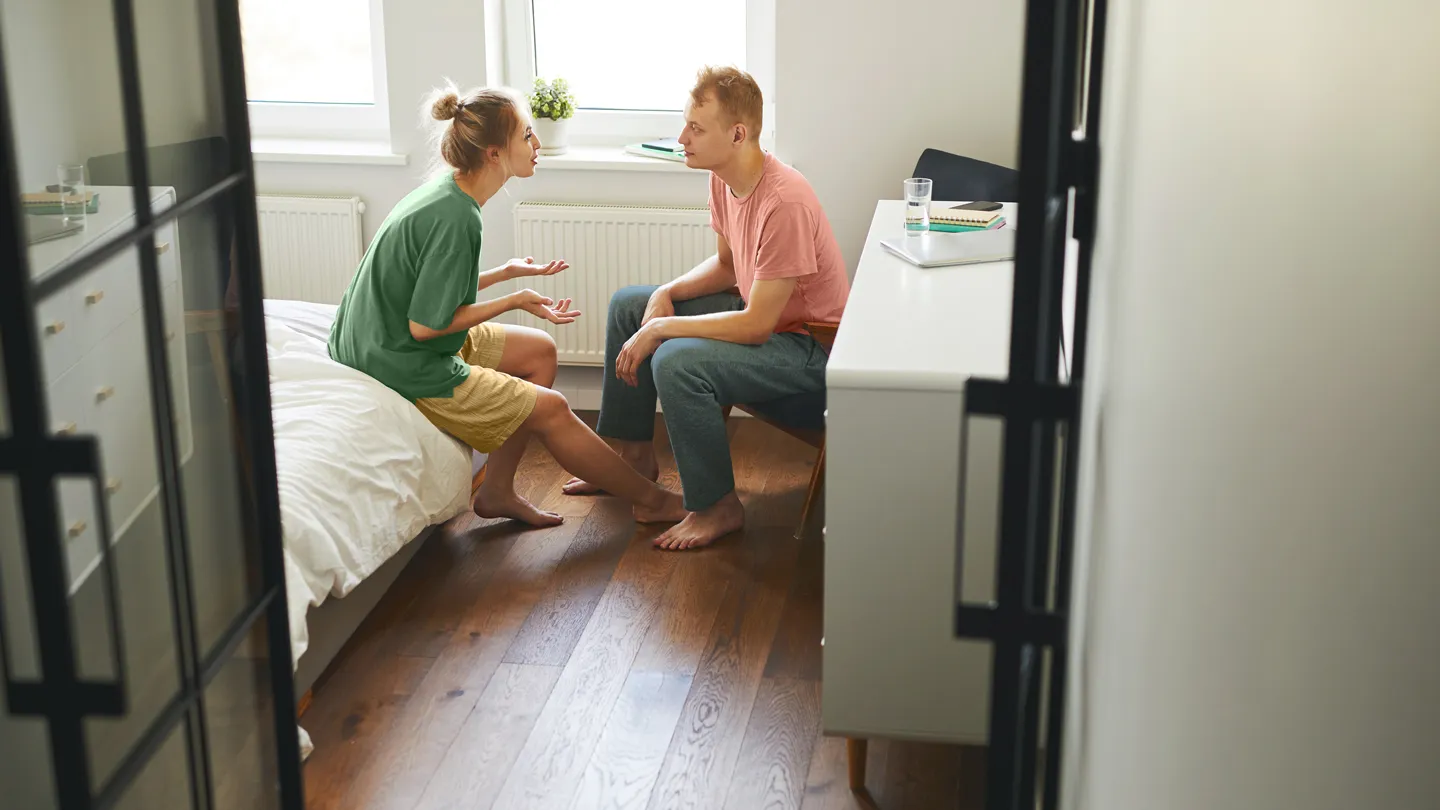 couple having a serious talk in their bedroom