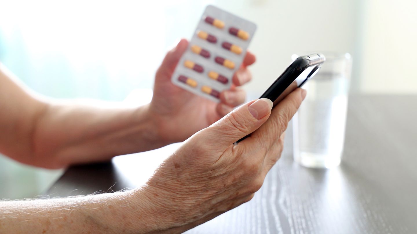 elder woman taking blood pressure medication