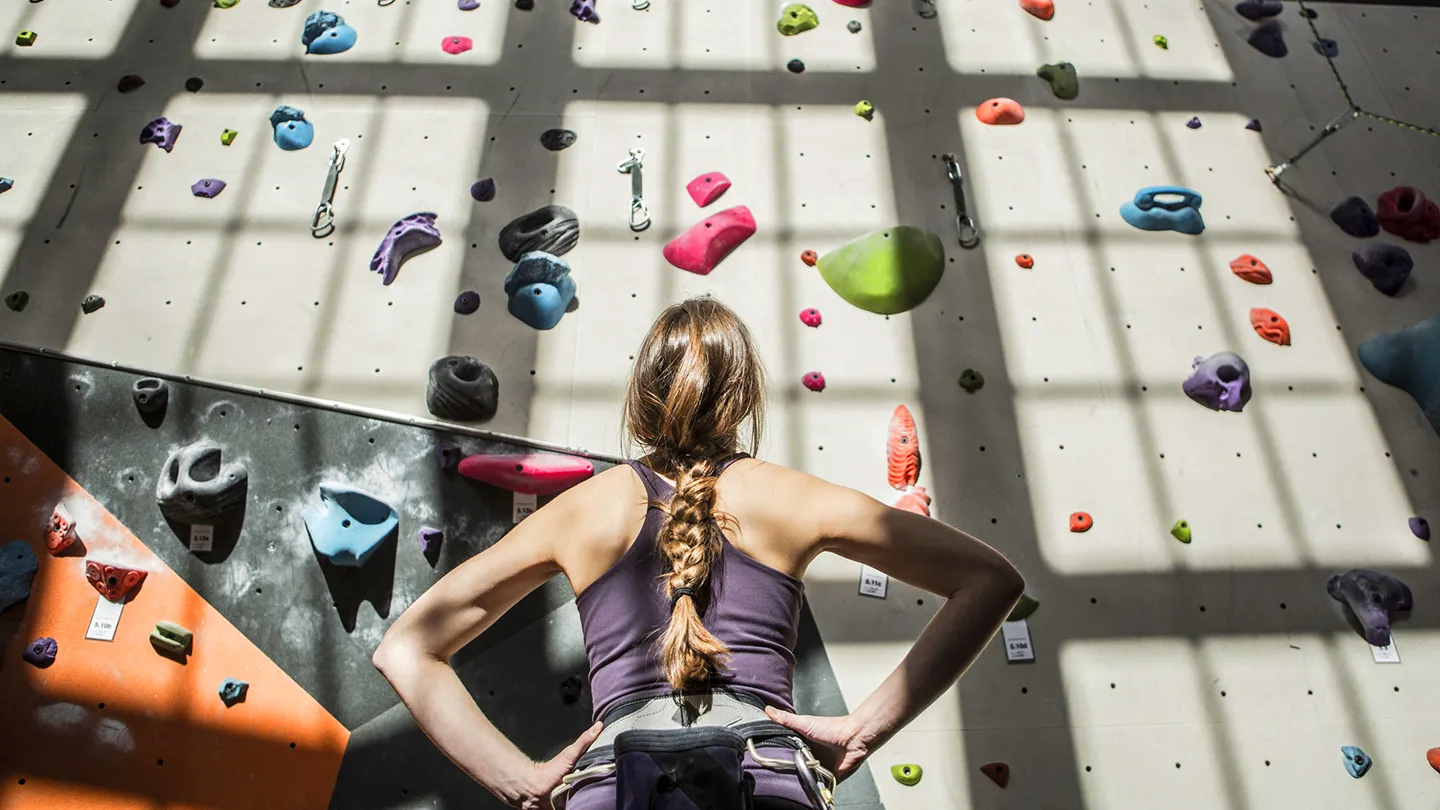 woman looking at rock bouldering wall
