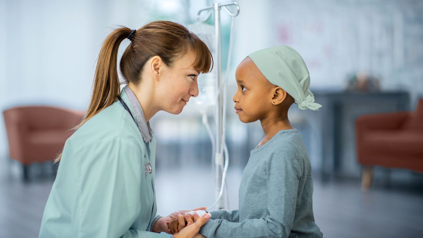 little girl with doctor in hospital cancer sharing a moment of hope