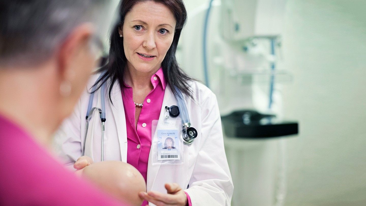 a woman meeting with her doctor to discuss breast lumps