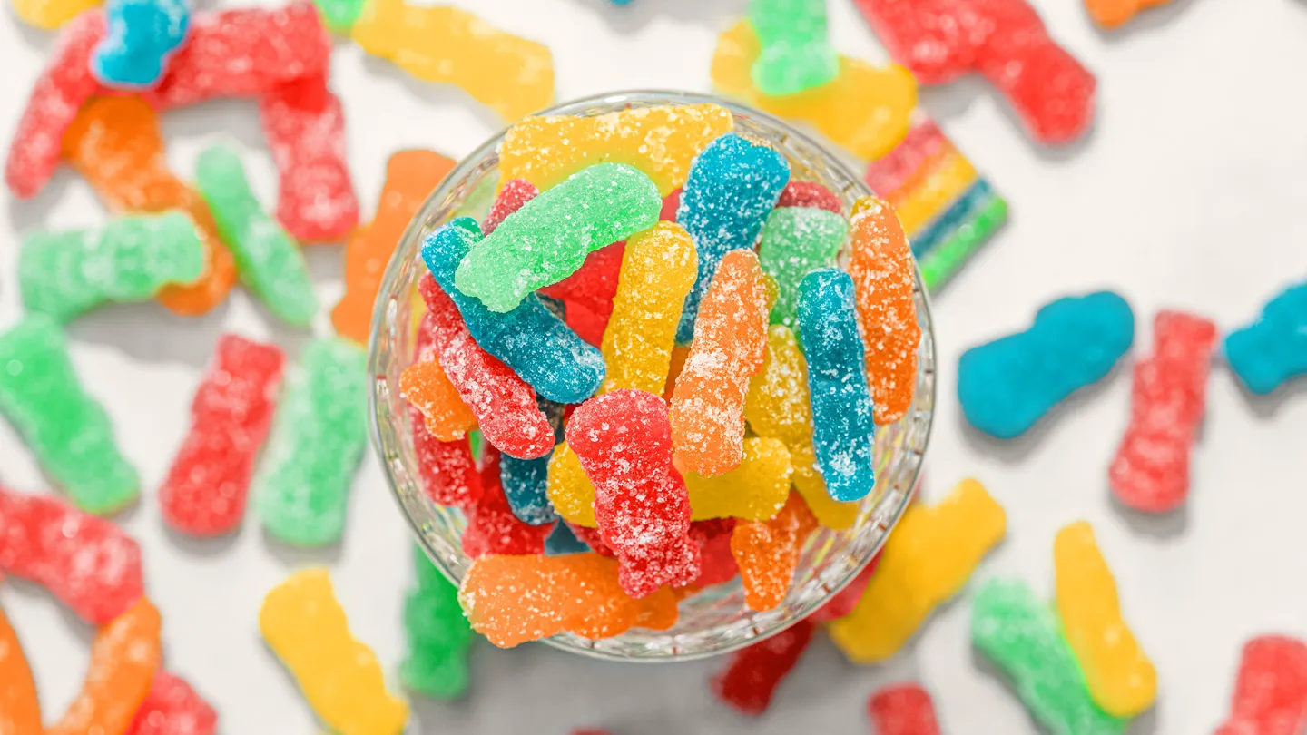 sour patch kids candies in a glass dish shot from above