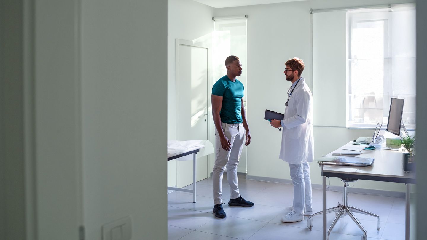 young Black man talking with his doctor